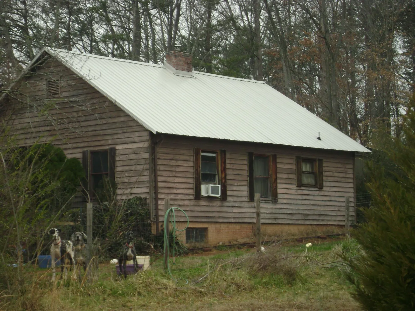 White metal roof on an old wood sided farmhouse, from a Metal Roof Installation job in Frankford